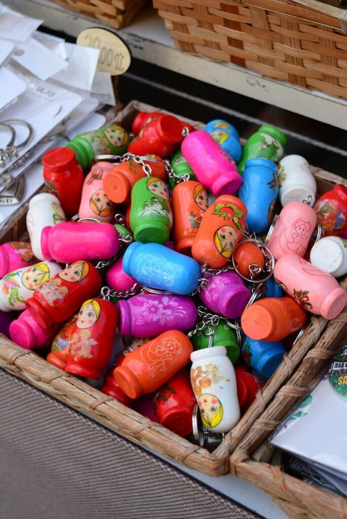 Vibrant collection of Matryoshka doll keychains displayed in a market basket.